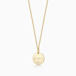 Front of 1/2 inch 14k Yellow Gold Disc Charm Necklace with Single Diamond Engraved with a Date